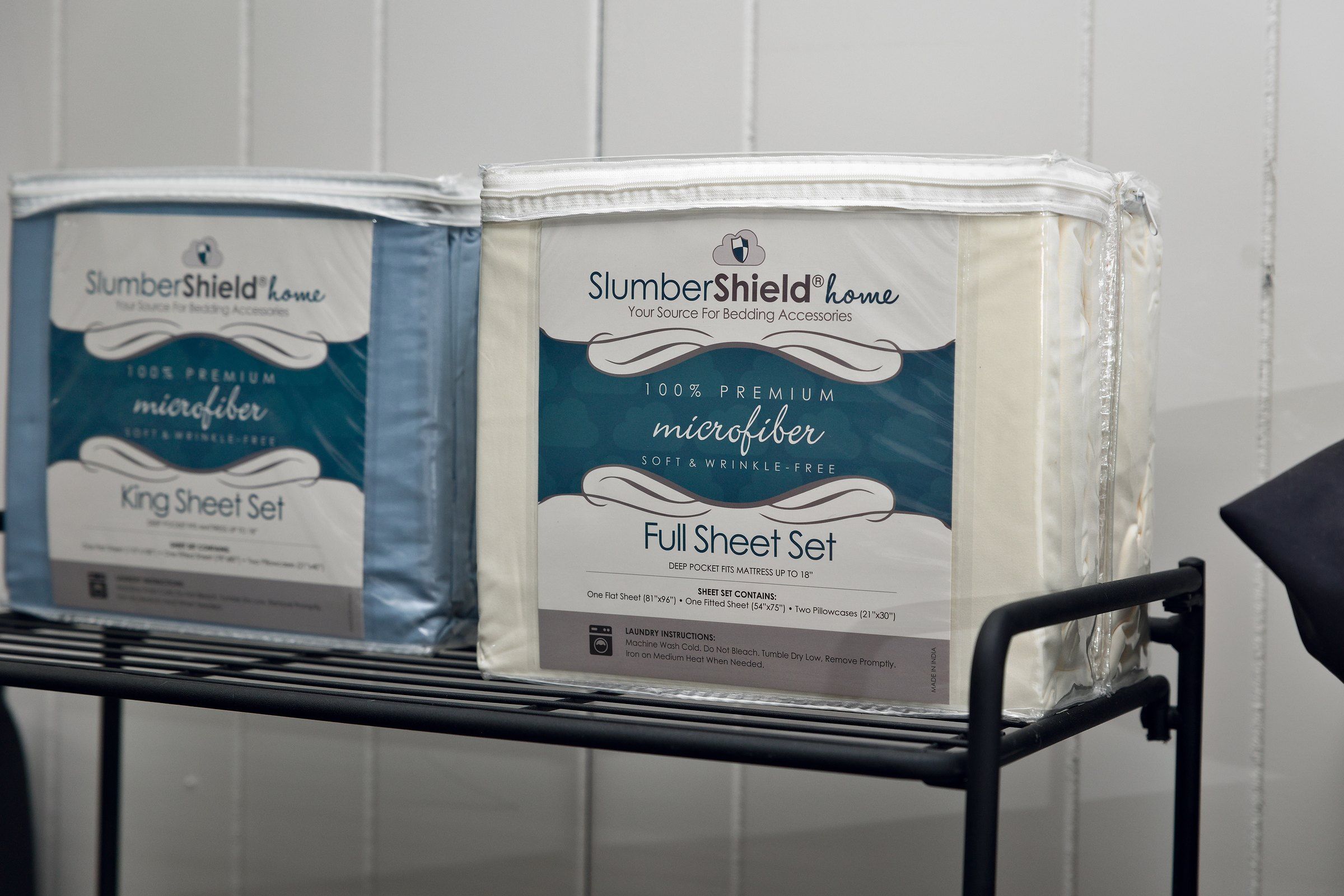 SlumberShield microfiber sheet sets on a rack in the store