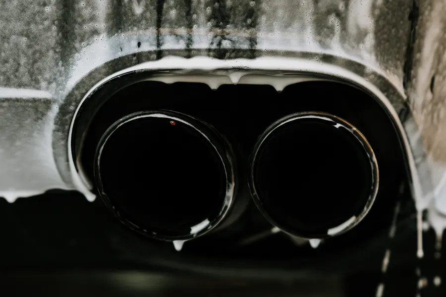 Foam running off a pair of polished exhaust tips.