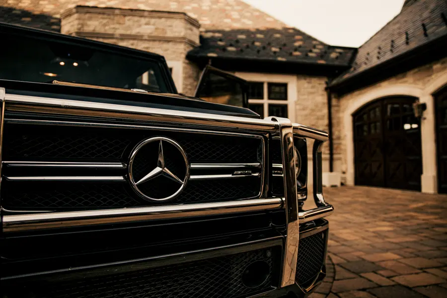 The grille and star of a finished G-Wagon against warm stone.