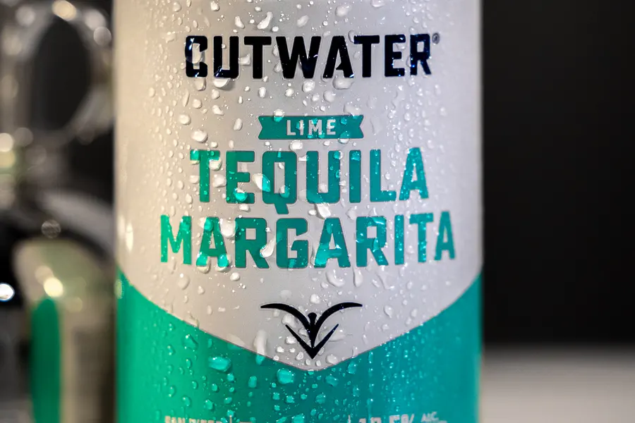 A Cutwater lime margarita can, cold and running with water.
