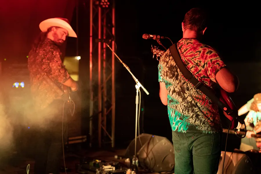 Two players in warm smoke, one in a cowboy hat.