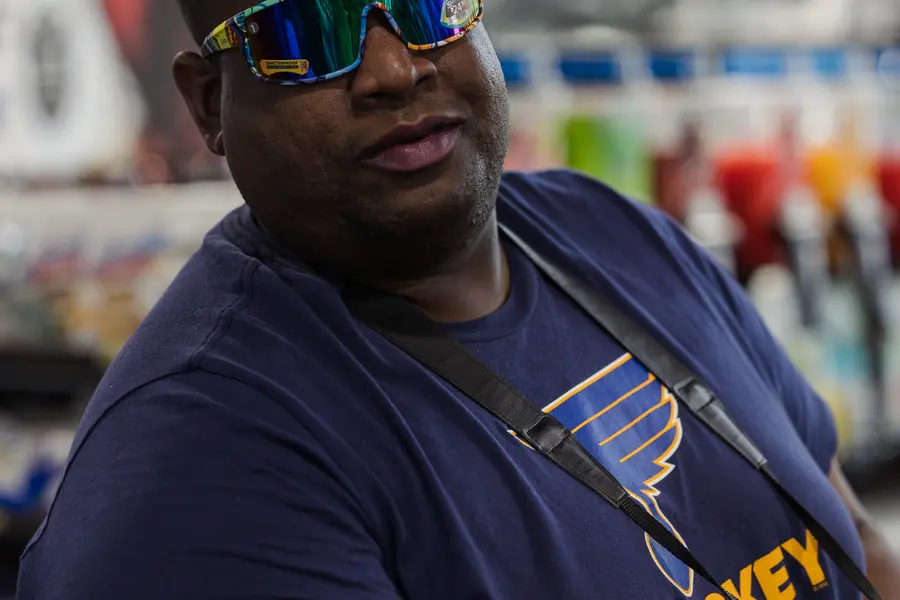 A staff portrait in the forecourt, sunglasses pushed up.